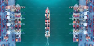 Aerial top view panoramic container ship moving pass sea port warehouse and crane ship working for delivery containers shipment, logistic import import or transportation concept.