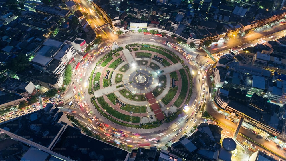 Aerial view highway road intersection roundabout or circle at night for transportation, distribution or traffic background.