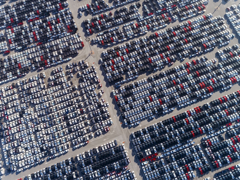 Aerial view car park at sea port or manufacture waiting for logistics ,shipping or export to worldwide.