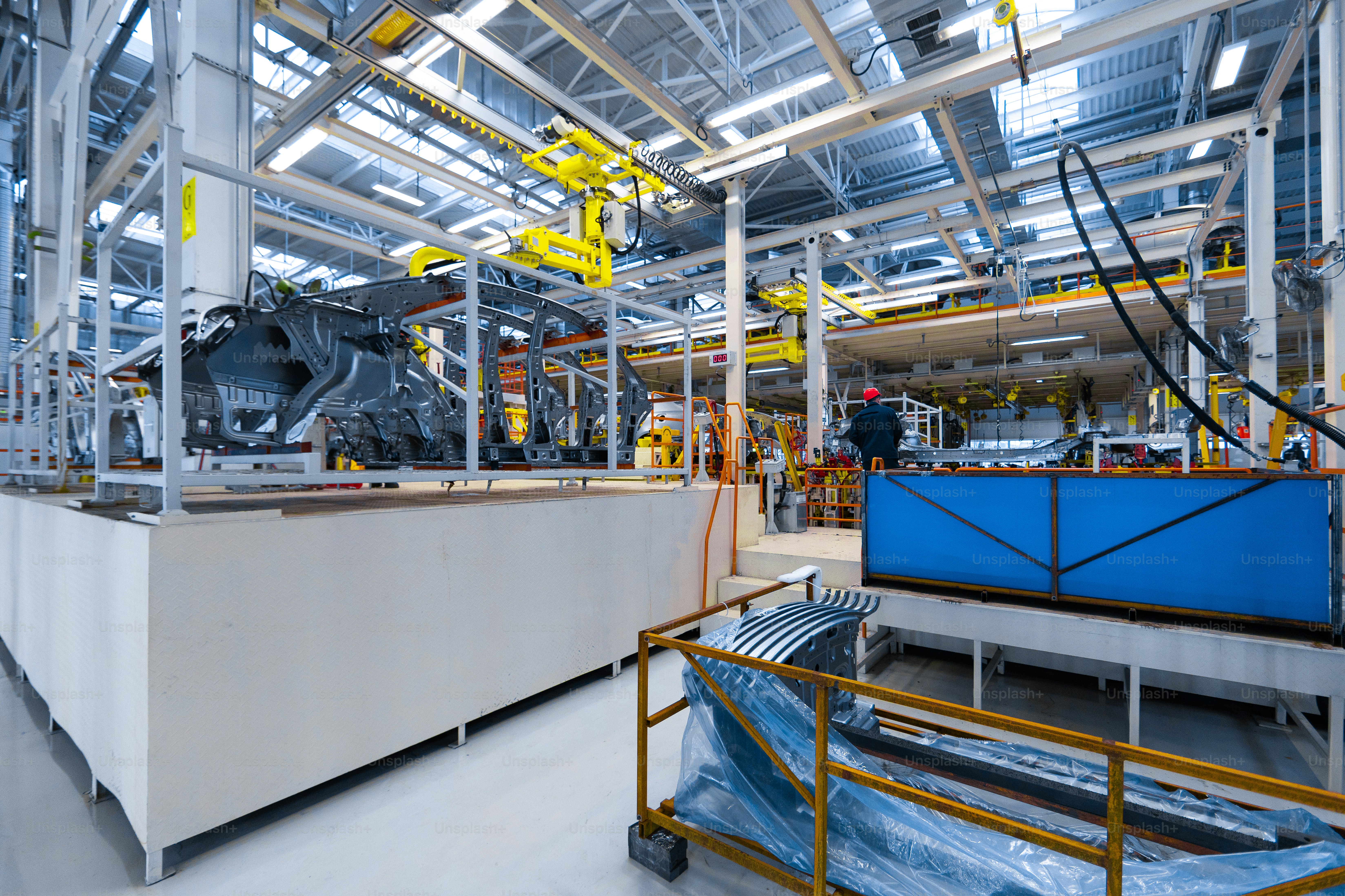 Workers assemble car. modern automated assembly line for cars. latest technological neutral technologies of production of cars at plant. Assembly of cars on conveyor