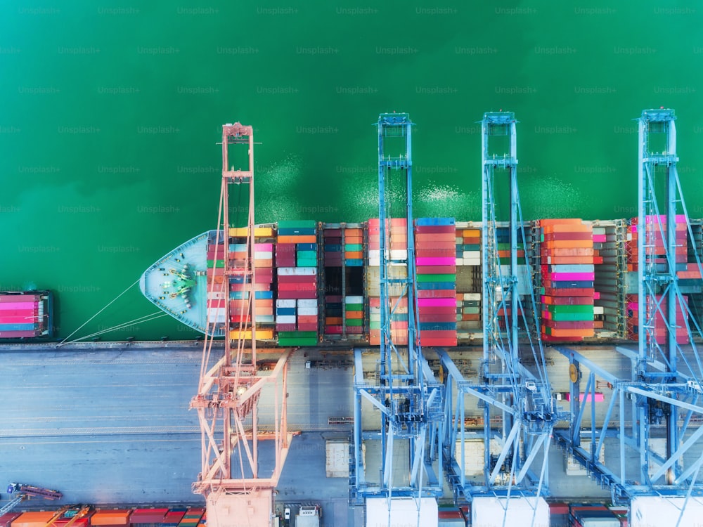 Aerial Top View Containerschiff im Seehafen und Arbeitskranbrücke Ladecontainer für Import Export, Versand oder Transport Konzept Hintergrund.