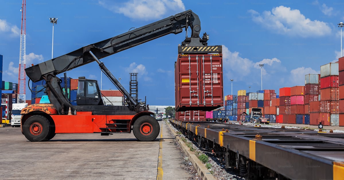 Forklift truck working in container warehouse loading container to ...