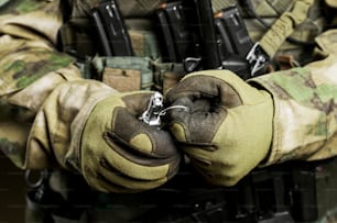 Soldado em munição de combate total puxa um cheque de uma granada. Mídia mista