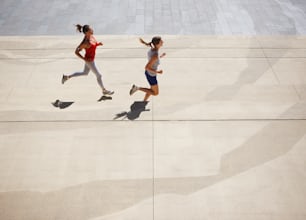 a couple of people that are running down a sidewalk