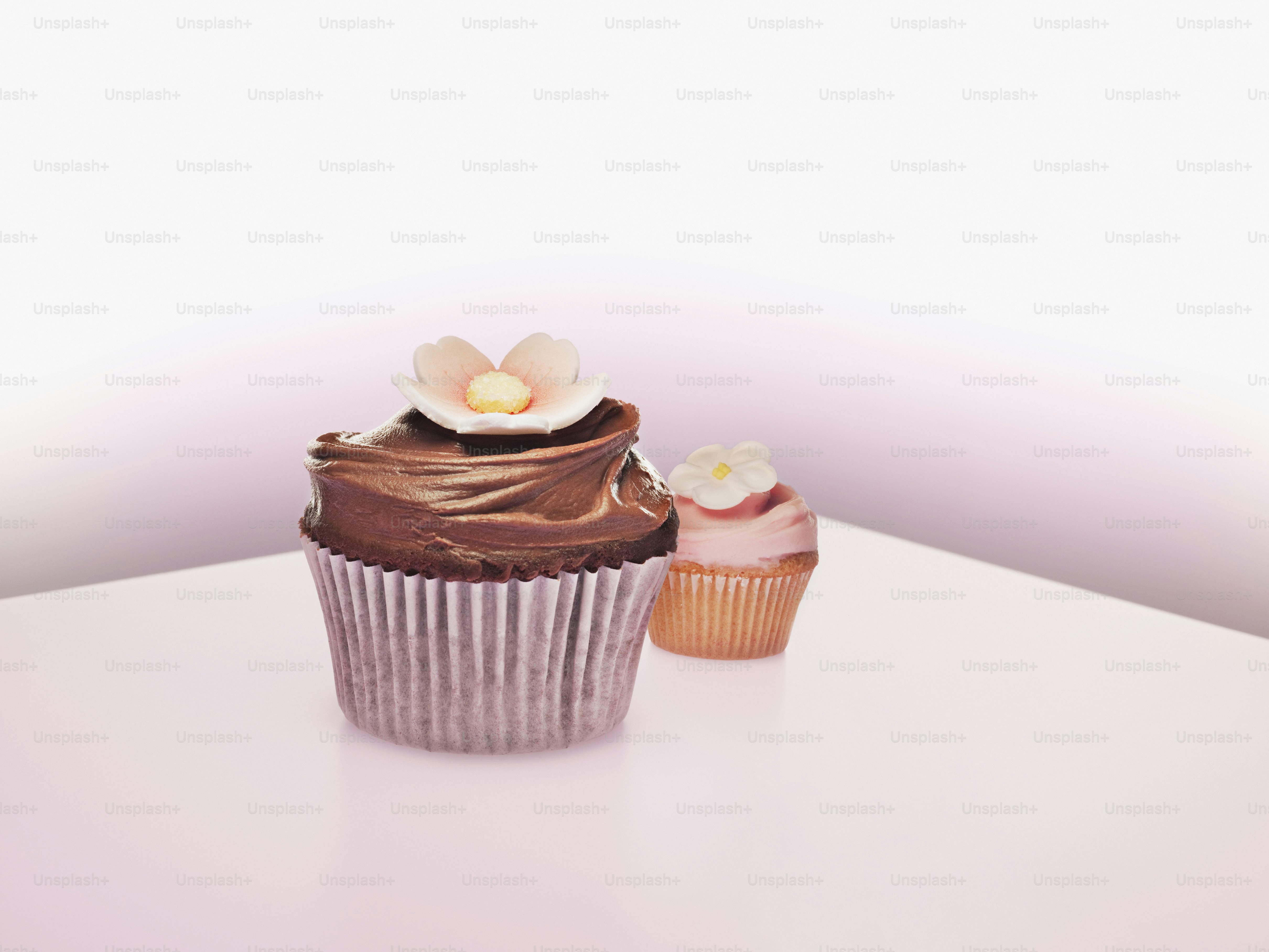 a chocolate cupcake with a flower on top of it