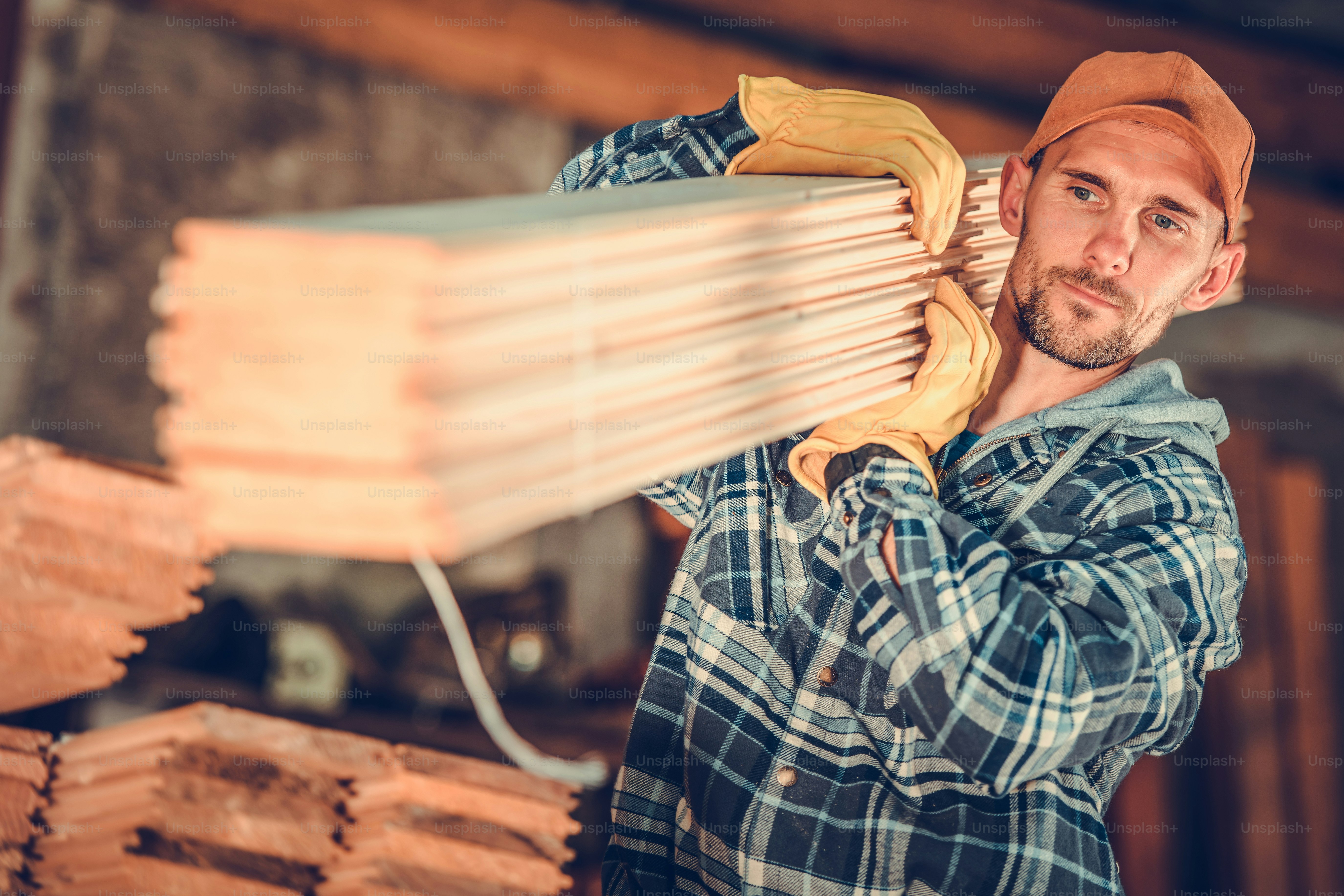 Caucasian Lumber Contractor in His 30s with Wooden Planks on His Shoulder. Construction Theme