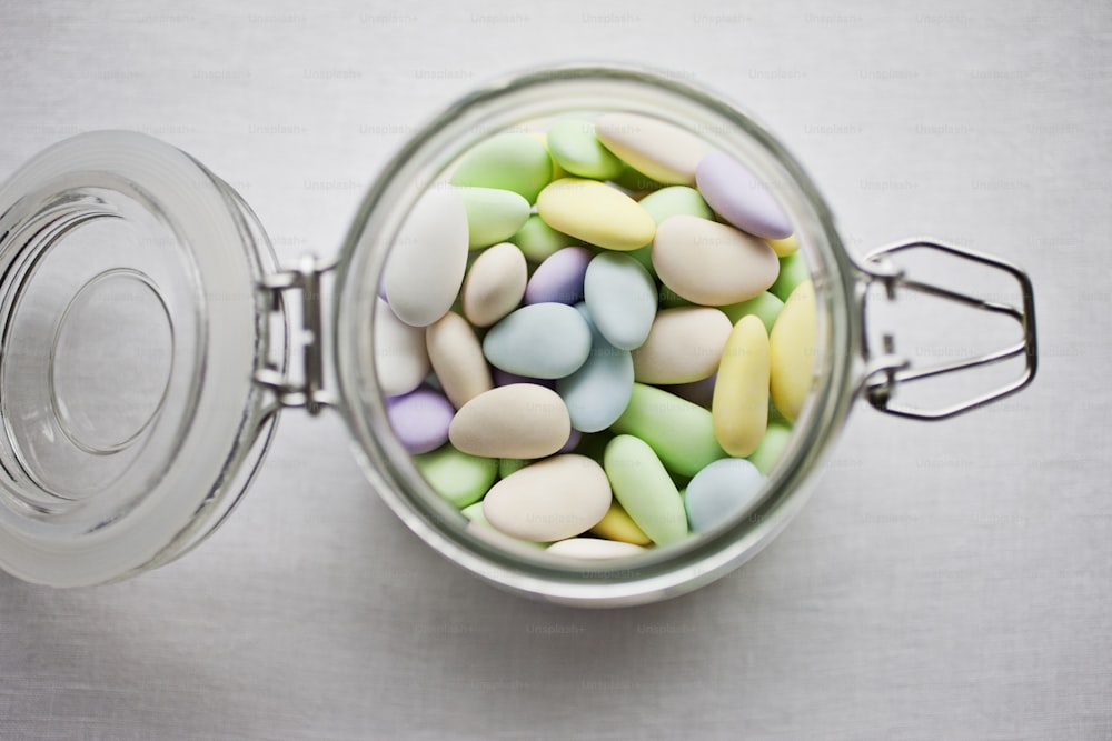 a glass jar filled with colorful candy beans