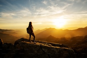 Hiker meets the sunset on the Moro rock in Sequoia national park, California, USA.