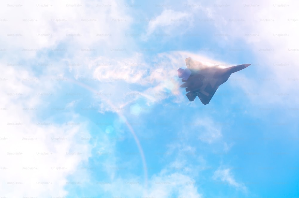 One military fighter aircraft at high speed, flying high clouds in the sky, sunshine glare