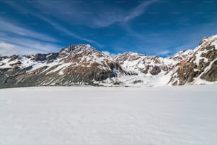 Winter landscape of snow mountain against blue sky. Beautiful nature scenery background.