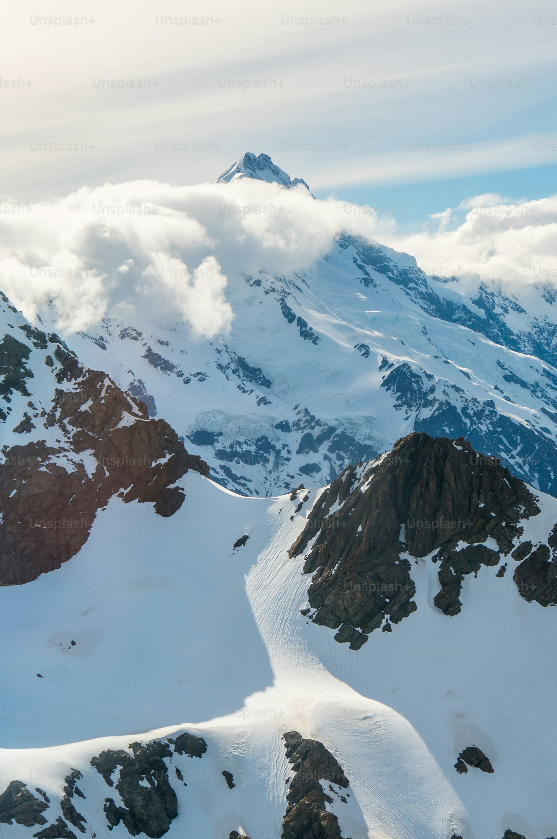 A very tall mountain covered in snow under a cloudy sky photo – Nepal ...