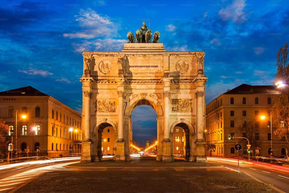 Siegestor (Victory Gate) in the evening. Motion blur of car lights because of long exposure. Munich, Bavaria, Germany