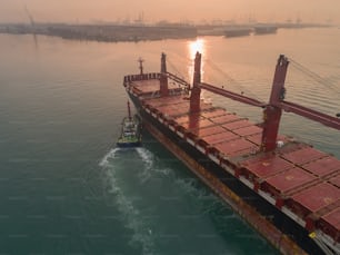 Empty container ship going to sea port for load container at crane. Logistic business, import export, shipping or transportation.