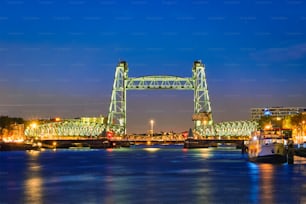 View of Rotterdam landmark De Hef - the first railroad bridge of its kind in Europe illuminated at night. Rotterdam, Netherlands
