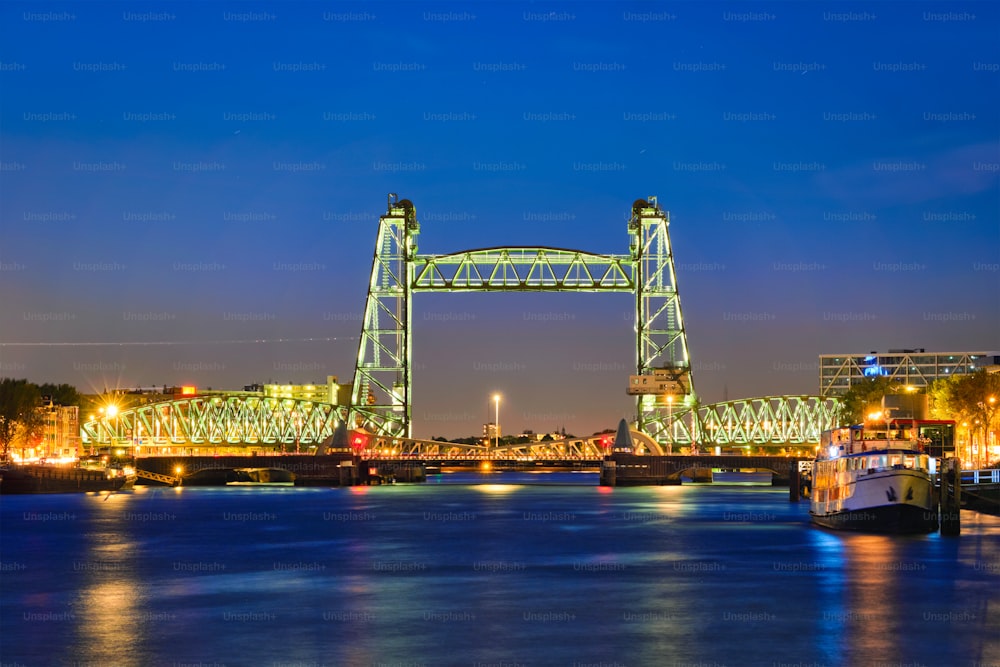 View of Rotterdam landmark De Hef - the first railroad bridge of its kind in Europe illuminated at night. Rotterdam, Netherlands
