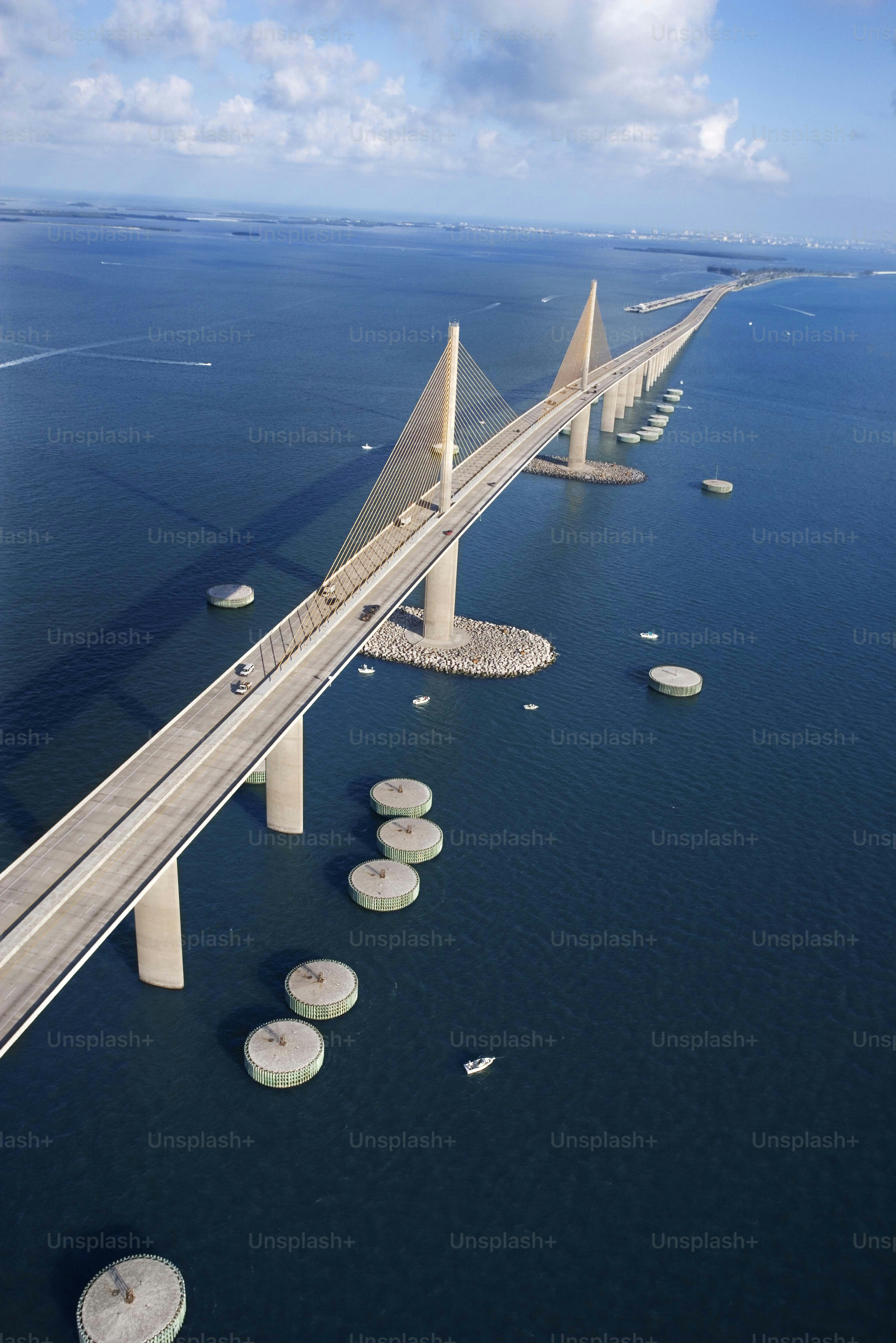 an aerial view of a bridge over a body of water