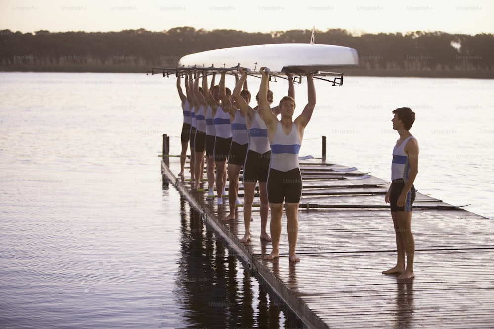 a group of men standing on top of a pier