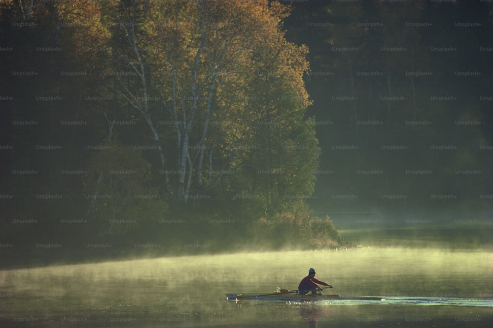 a person rowing a boat on a lake