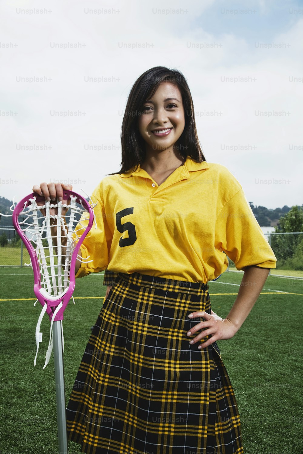 a girl in a skirt holding a tennis racket