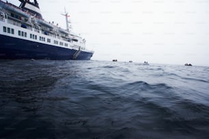 a large boat in the ocean with people in it