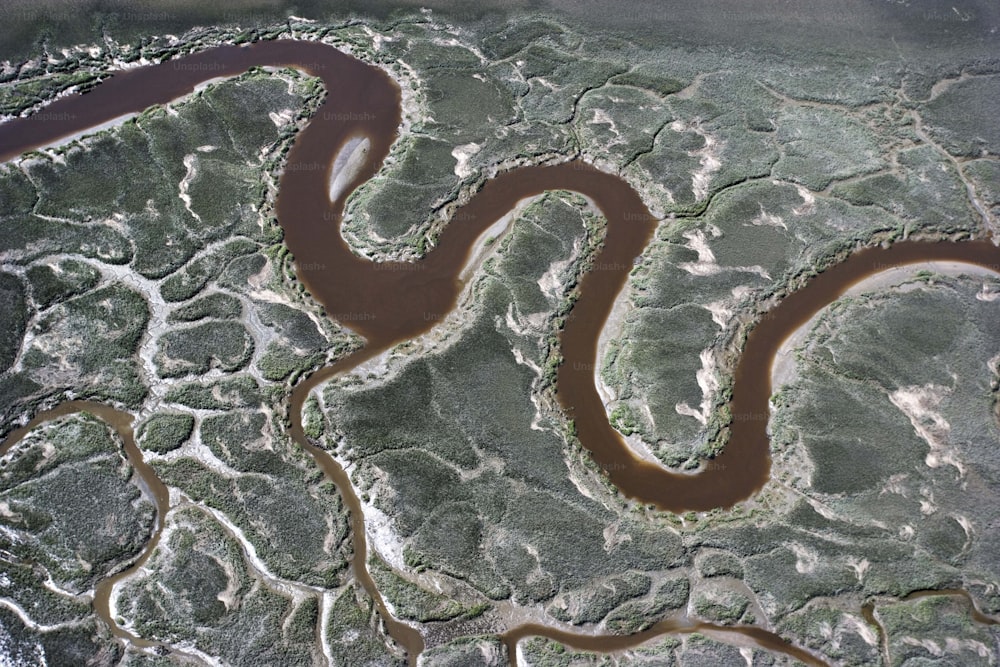 an aerial view of a river and land