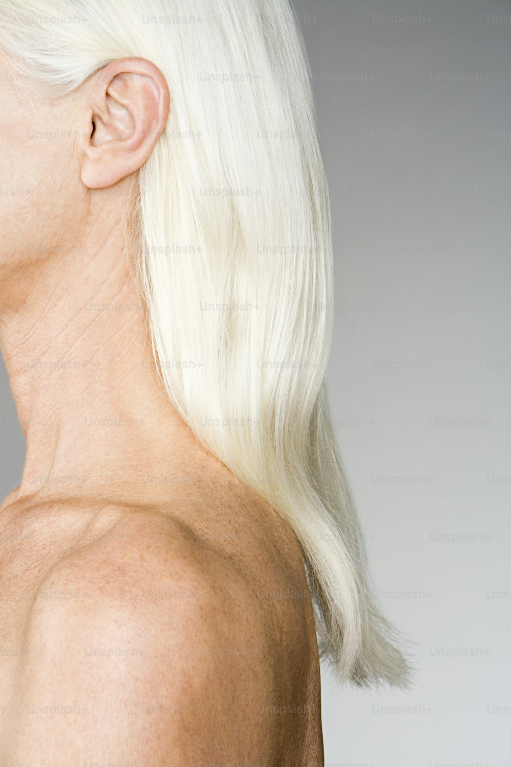 a woman with white hair and no shirt on