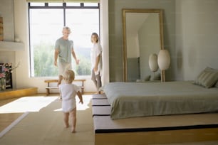 a man and a woman and a child in a bedroom