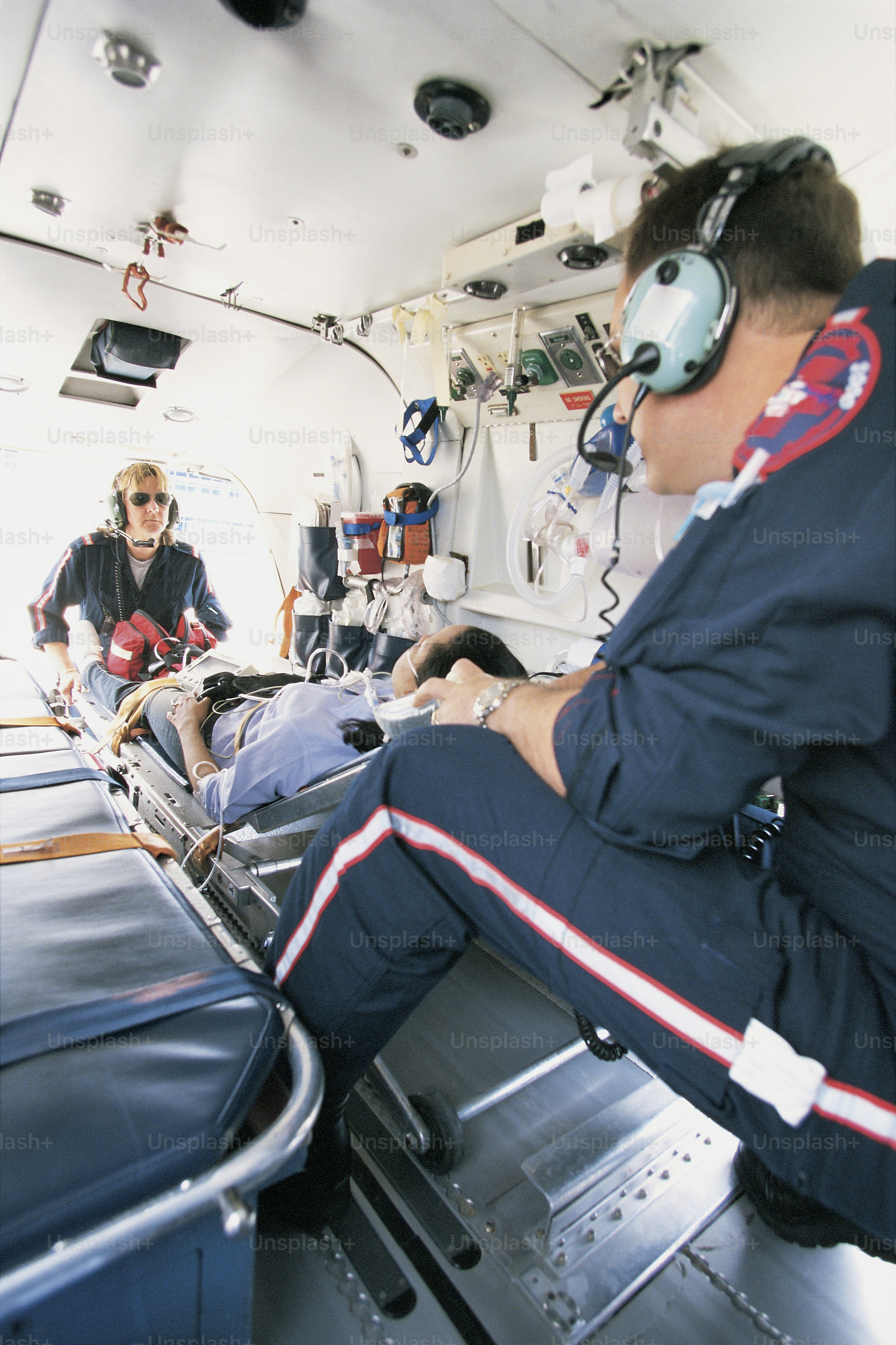 a man wearing headphones sitting in an airplane