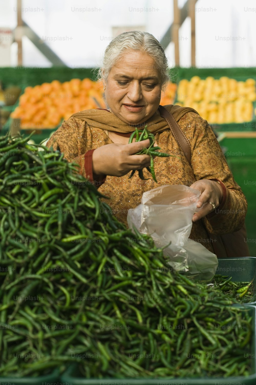 a woman holding a bag of green beans