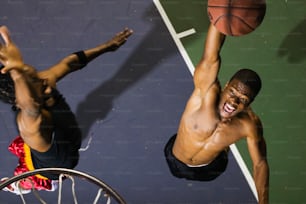 a couple of men standing on top of a basketball court