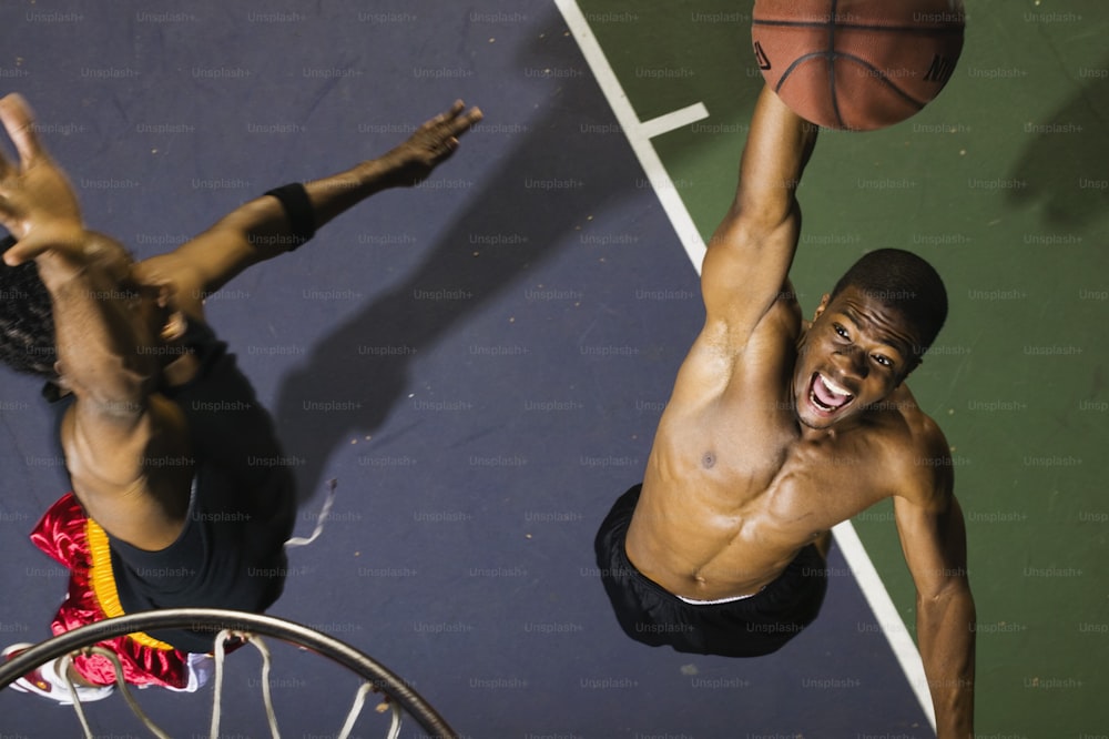 a couple of men standing on top of a basketball court