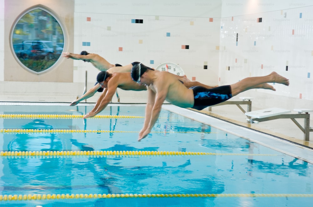 a man diving into a swimming pool