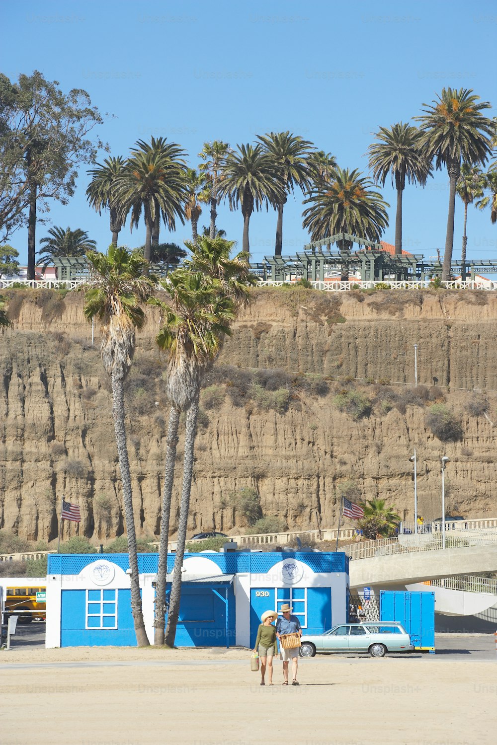 a couple of people standing in front of a blue building