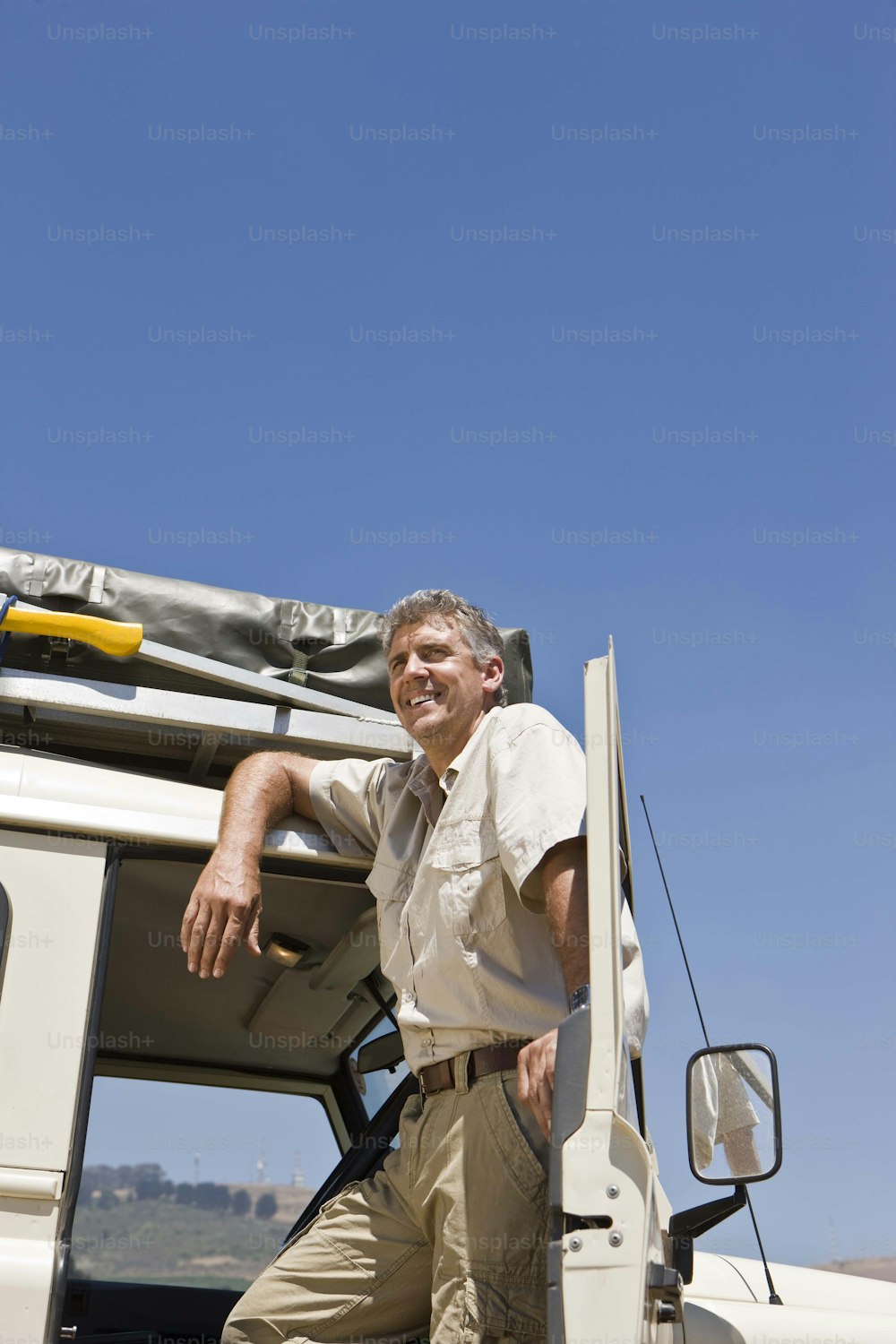 a man leaning on the door of a truck
