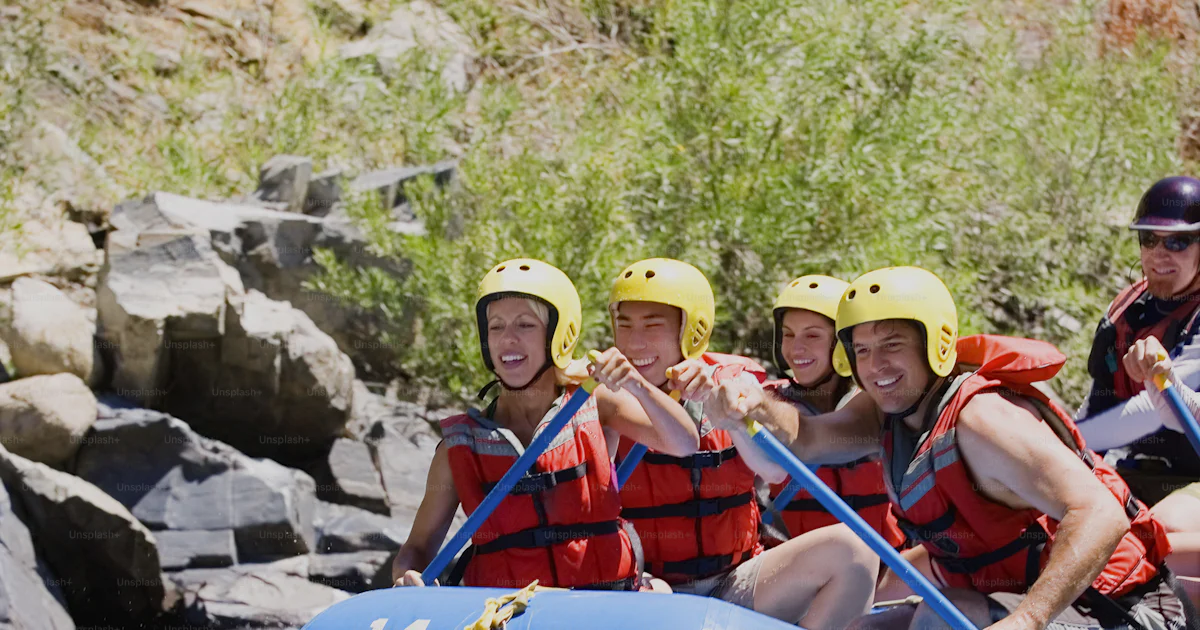 Person Riding Raft A group of people riding a raft down a river photo – Rapids - river ...