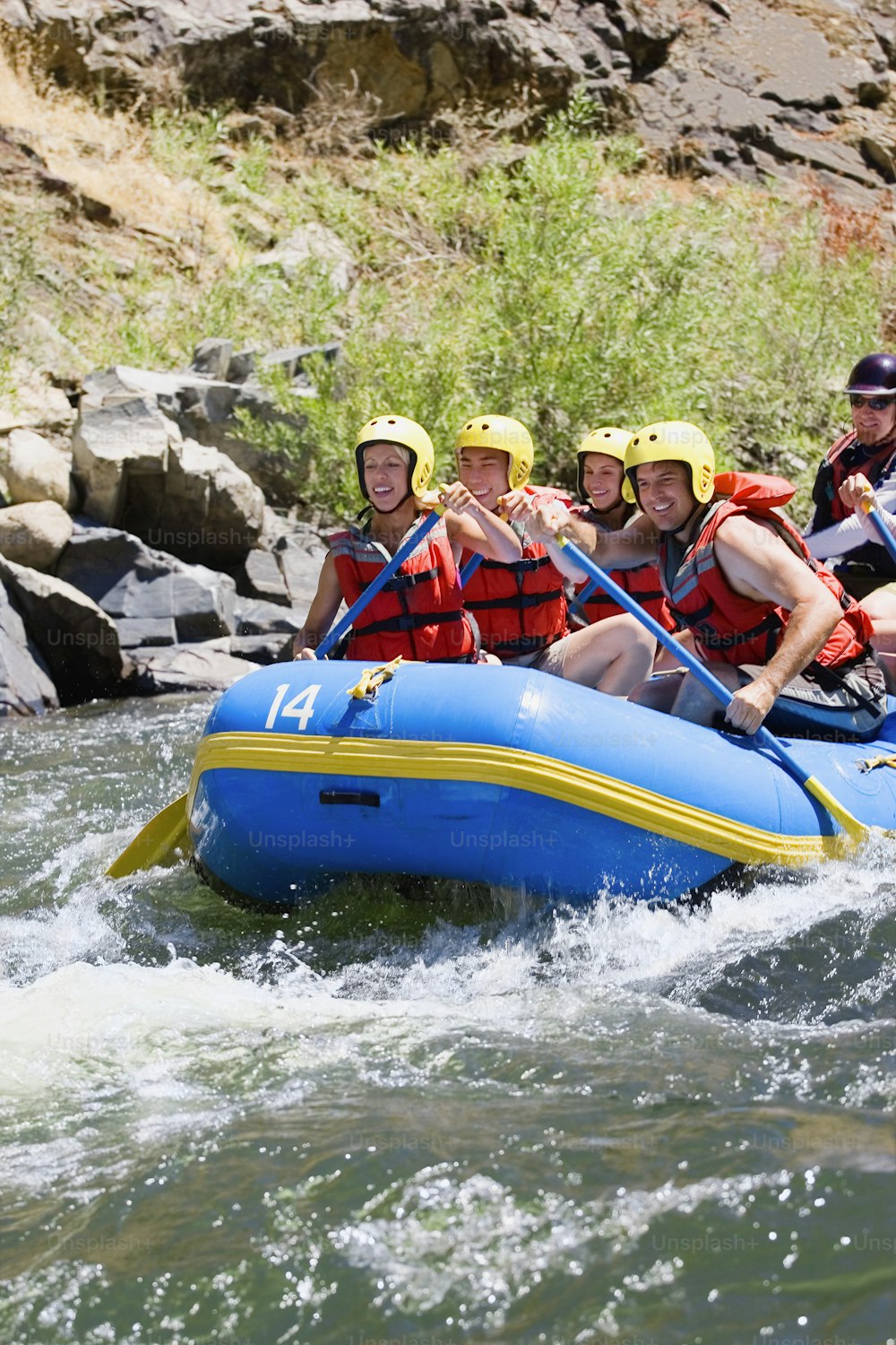 a group of people riding a raft down a river