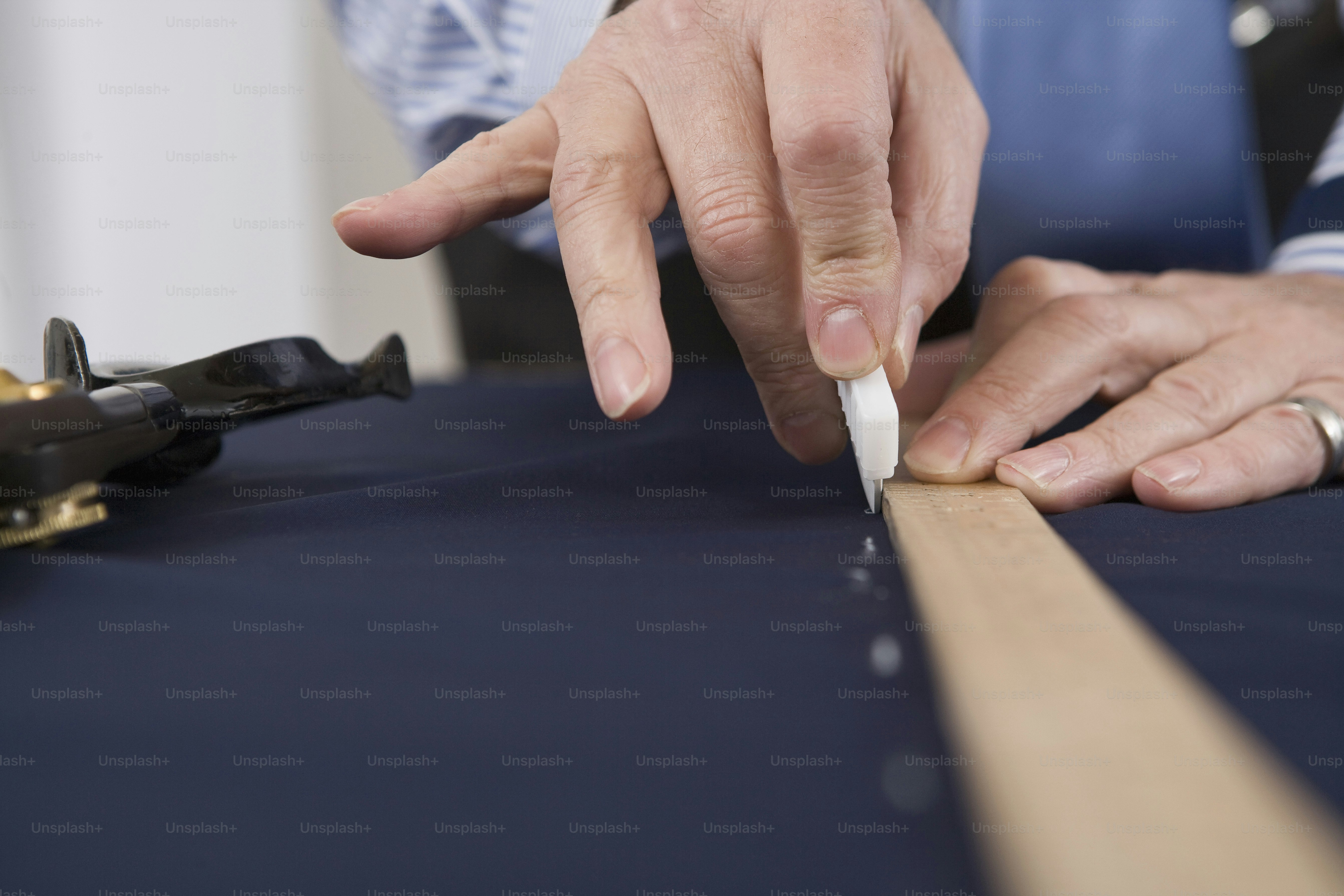 A close up of a person cutting a piece of wood photo – Fashion Image on ...
