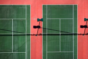 a tennis court with two green tennis courts