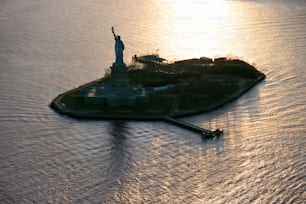 a small island with a statue of liberty on top of it