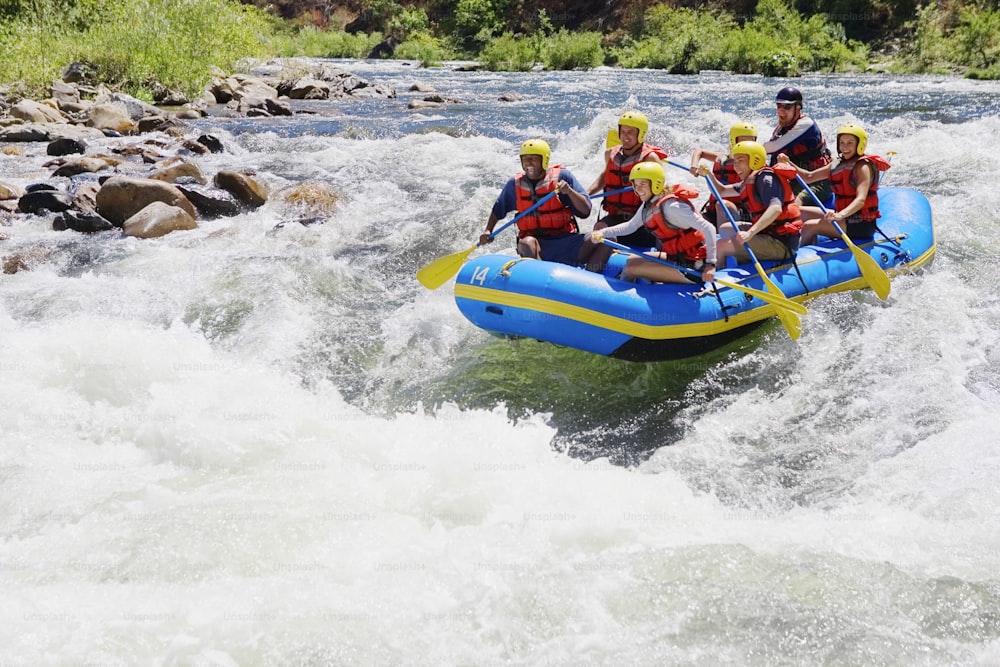 a group of people riding a raft down a river