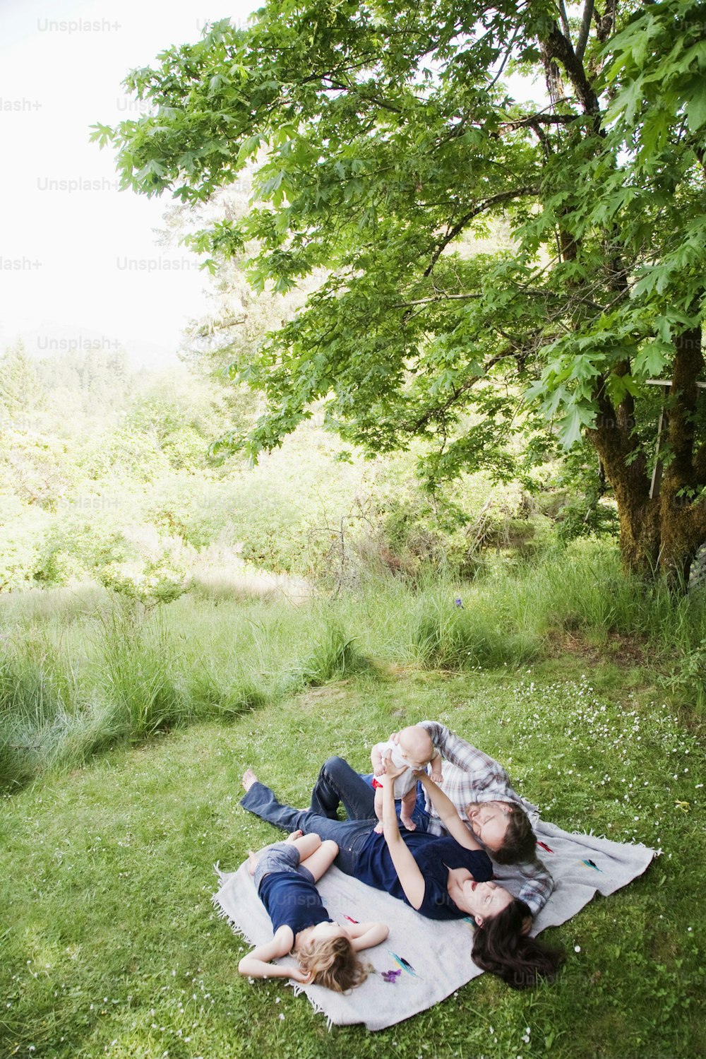 a group of people laying on top of a blanket