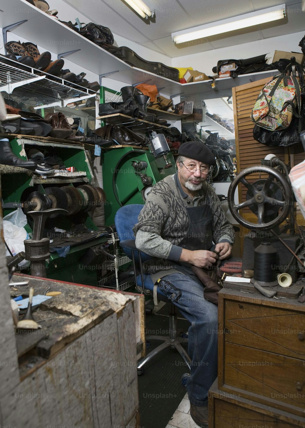 a man working on a sewing machine in a shop