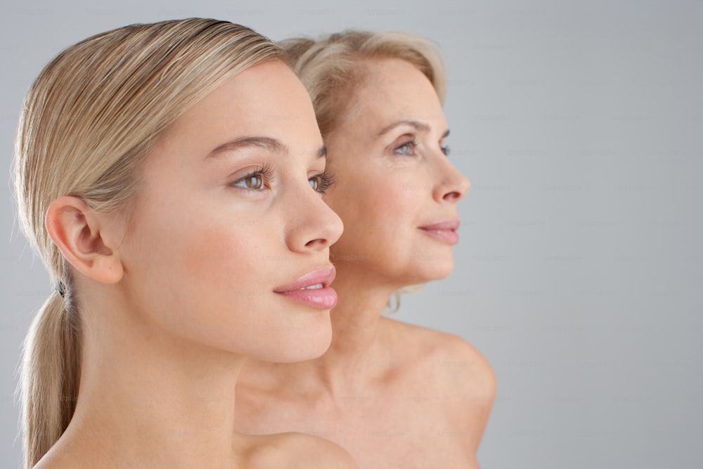 a woman looking at her reflection in the mirror