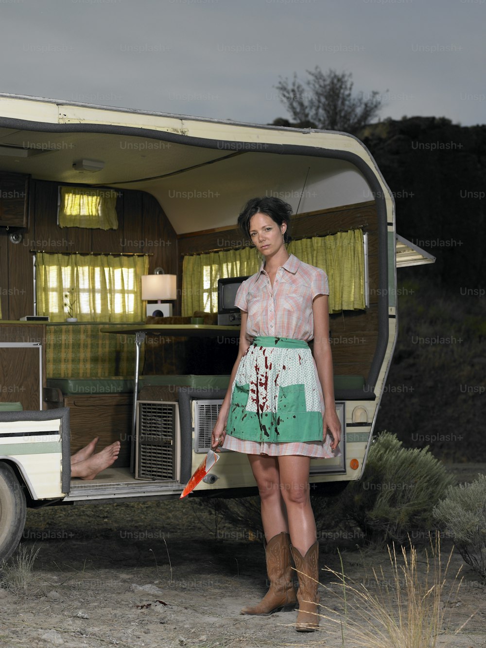 a woman standing in front of a trailer