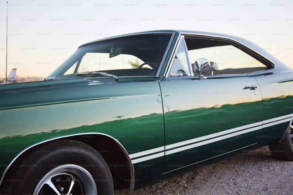 a green car parked on the side of the road