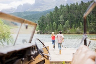 a man and a woman walking on a dock