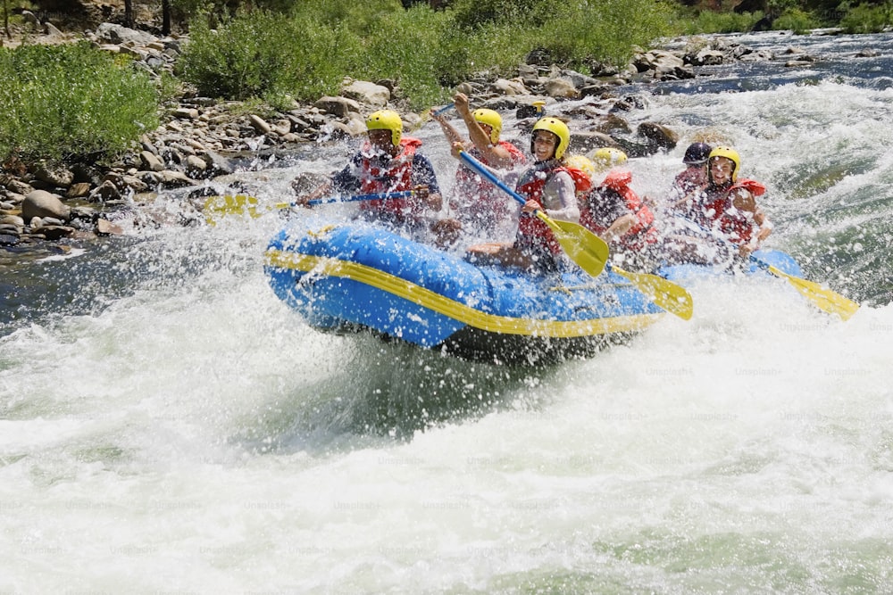 a group of people riding a raft down a river