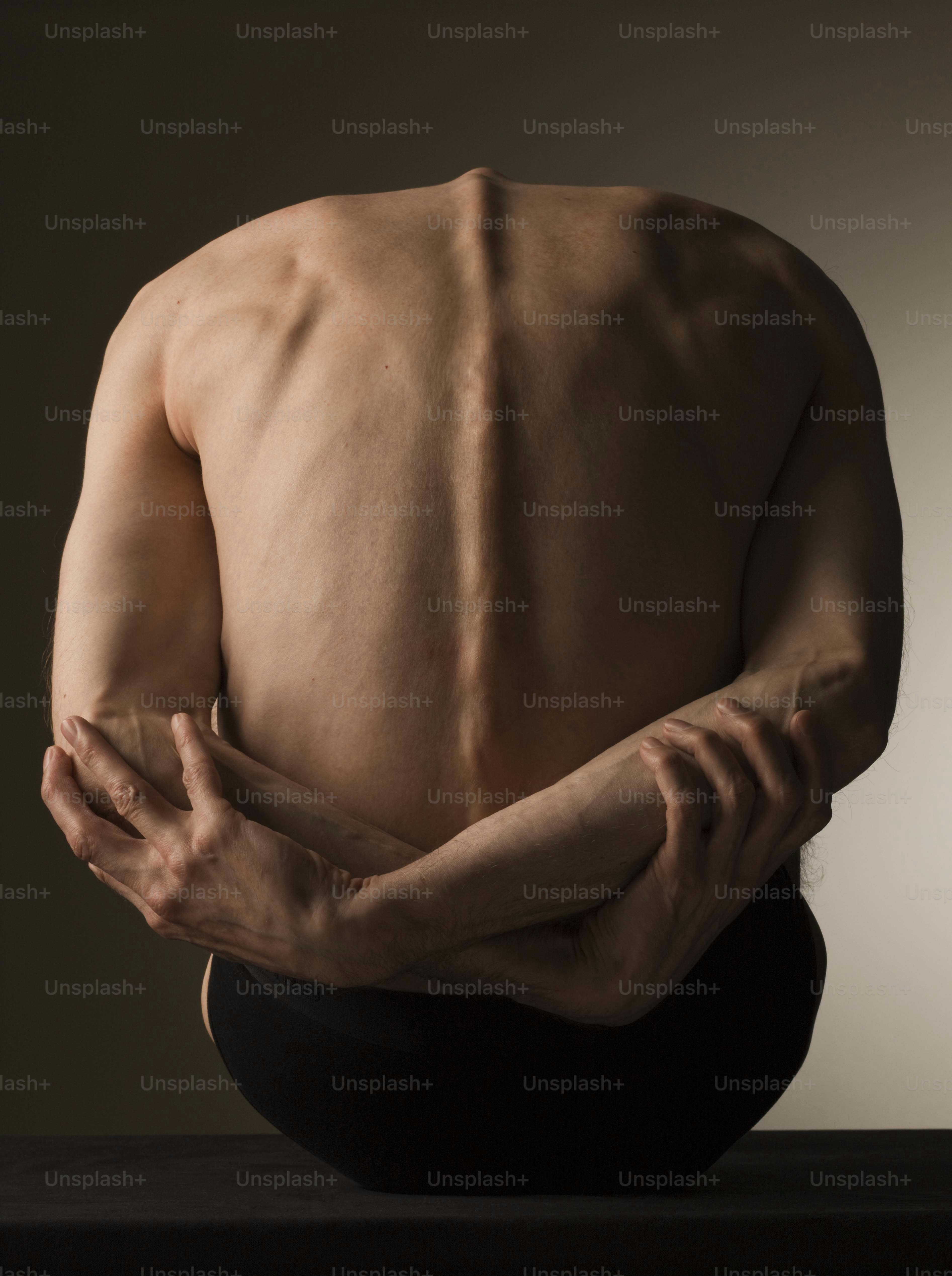 a man with his hands on his knees