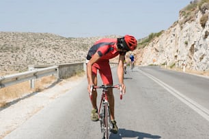 a man riding a bike down a road