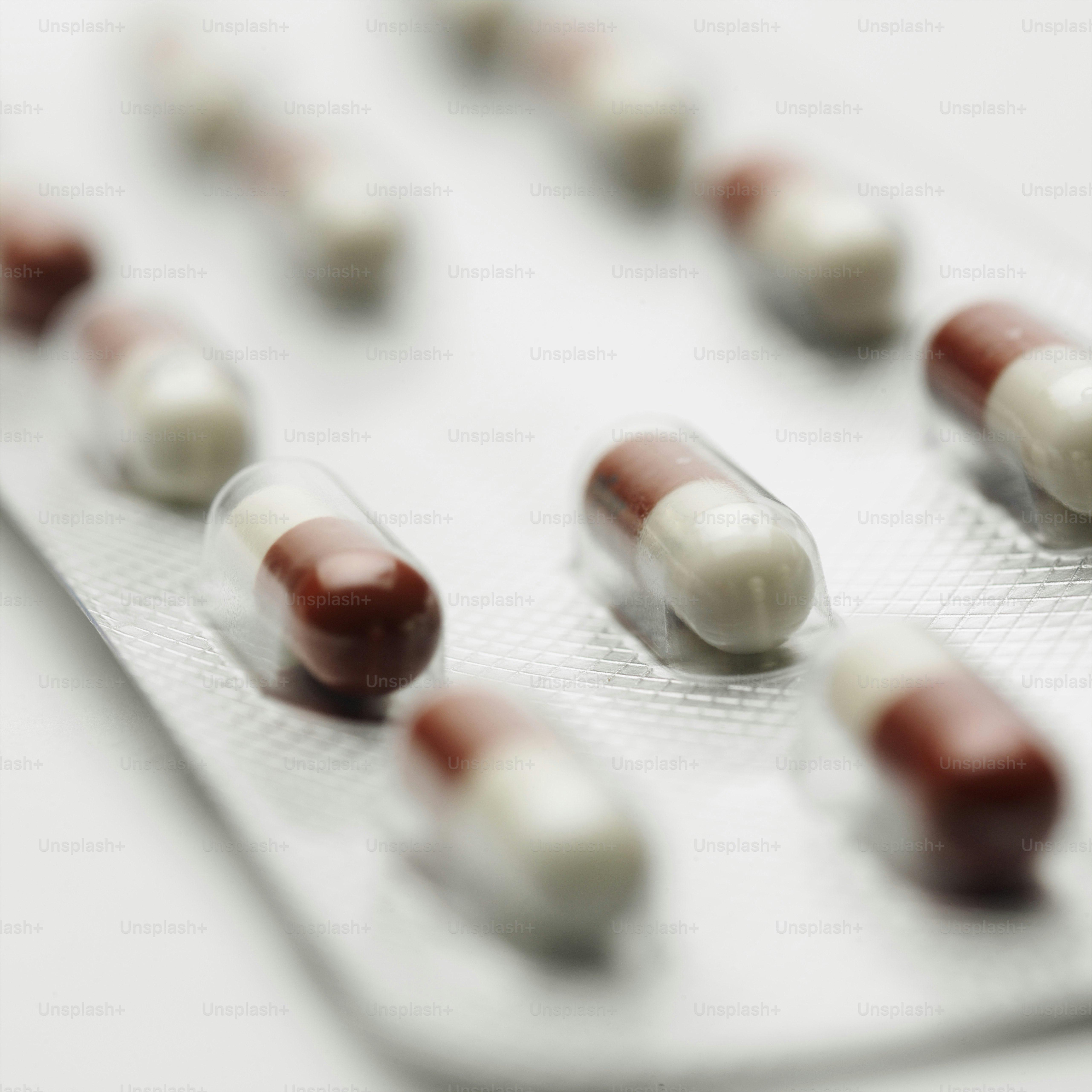 a close up of many pills on a tray